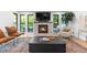 Cozy living room with brick fireplace, large windows, and comfortable seating arrangement at 3235 E Easter Pl, Centennial, CO 80122