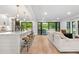 Bright living area with open floor plan, bar seating, and backyard access through sliding glass doors at 3235 E Easter Pl, Centennial, CO 80122
