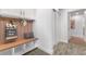Inviting mudroom with storage bench, hooks, and neutral decor, creating a functional and stylish entryway at 3235 E Easter Pl, Centennial, CO 80122
