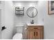 Modern powder room with wood vanity, decorative mirror, and shiplap wall paneling at 3235 E Easter Pl, Centennial, CO 80122