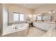 Bright bathroom with tub, double sinks, vanity, and great natural light at 714 Skywalker Pt, Lafayette, CO 80026