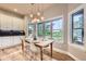 Dining room features a wooden table, modern lighting, large windows and hardwood flooring at 714 Skywalker Pt, Lafayette, CO 80026