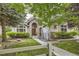 Charming home featuring a stone archway over the wooden front door, lush landscaping and mature trees at 714 Skywalker Pt, Lafayette, CO 80026