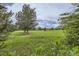 Green golf course view with mature trees and blue skies at 714 Skywalker Pt, Lafayette, CO 80026