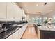 Modern kitchen featuring a large island, sleek countertops, and stainless steel appliances at 714 Skywalker Pt, Lafayette, CO 80026