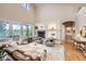 Spacious living room with hardwood floors, fireplace, and large windows showcasing the outdoor view at 714 Skywalker Pt, Lafayette, CO 80026