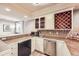 Basement wet bar with wine storage, sink, microwave, and ample counter space at 714 Skywalker Pt, Lafayette, CO 80026