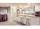 Finished basement wet bar area features a mirrored wall and bar stool seating at 714 Skywalker Pt, Lafayette, CO 80026