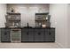 Basement wet bar with dark cabinetry and sleek countertops at 4339 W 33Rd Ave, Denver, CO 80212