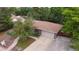 Aerial view of a home with a spacious driveway and mature trees surrounding the property at 7140 S Uinta St, Centennial, CO 80112