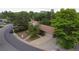 Aerial view of a home with a spacious driveway and mature trees surrounding the property at 7140 S Uinta St, Centennial, CO 80112