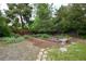 Backyard area features garden beds, walking path and mature landscaping at 7140 S Uinta St, Centennial, CO 80112