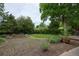 Large grassy backyard with lush, mature landscaping, garden beds and treed perimeter at 7140 S Uinta St, Centennial, CO 80112