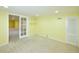 Carpeted basement room featuring neutral paint, closet, access to main basement, and a window at 7140 S Uinta St, Centennial, CO 80112