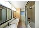 Bathroom featuring dual sinks with granite counters, tiled shower and separate tub at 7140 S Uinta St, Centennial, CO 80112