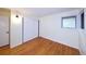 Bedroom with hardwood floors, sliding closet doors and window with natural light at 7140 S Uinta St, Centennial, CO 80112
