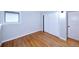 Bedroom with hardwood floors, sliding closet doors and window with natural light at 7140 S Uinta St, Centennial, CO 80112