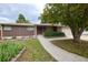 Well-maintained brick home with a charming walkway and mature landscaping at 7140 S Uinta St, Centennial, CO 80112