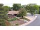 Charming brick home featuring a well-maintained front yard and mature trees at 7140 S Uinta St, Centennial, CO 80112