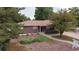 Charming brick home featuring a well-maintained front yard and mature trees at 7140 S Uinta St, Centennial, CO 80112