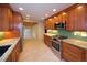 Bright kitchen with stainless steel appliances, granite countertops, and wooden cabinetry at 7140 S Uinta St, Centennial, CO 80112