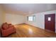 Bright living room featuring hardwood floors, a large window, and a cozy sofa at 7140 S Uinta St, Centennial, CO 80112