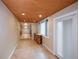 Sitting room with custom woodworking ceiling and tiled floors leading to kitchen at 7140 S Uinta St, Centennial, CO 80112
