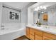 Bathroom featuring double vanity, soaking tub, and a window for natural light at 33633 Elk Run, Evergreen, CO 80439