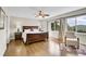Primary bedroom boasts hardwood floors, a ceiling fan and windows with mountain views at 33633 Elk Run, Evergreen, CO 80439