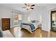 Vaulted ceiling bedroom with hardwood floors, ceiling fan and sliding glass door to balcony at 33633 Elk Run, Evergreen, CO 80439
