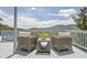 Outdoor patio with seating, table and sweeping mountain views at 33633 Elk Run, Evergreen, CO 80439