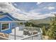 Exterior deck with seating overlooking a beautiful mountain landscape at 33633 Elk Run, Evergreen, CO 80439
