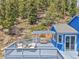 Relax on this lovely deck with shaded pergola and seating that is great for entertaining at 33633 Elk Run, Evergreen, CO 80439