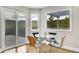 Bright dining room with hardwood floors, mountain view, glass table, and chairs at 33633 Elk Run, Evergreen, CO 80439