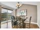 Dining room with modern chandelier and view of the forest and mountains beyond at 33633 Elk Run, Evergreen, CO 80439