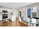 Modern kitchen featuring white cabinets, stainless steel appliances, island, and mountain view at 33633 Elk Run, Evergreen, CO 80439