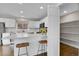 Open kitchen featuring a pantry, island with seating, and bright white cabinets at 33633 Elk Run, Evergreen, CO 80439