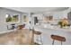 Eat-in kitchen featuring an island with bar stools, white cabinets, and stainless appliances at 33633 Elk Run, Evergreen, CO 80439