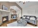 Inviting living room with fireplace, modern seating, and an open view to dining area at 33633 Elk Run, Evergreen, CO 80439