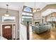 Inviting living room featuring hardwood floors, a fireplace, a view, and an open floor plan at 33633 Elk Run, Evergreen, CO 80439