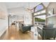 Spacious living room showcasing large windows and the entrance to the adjacent bedroom at 33633 Elk Run, Evergreen, CO 80439