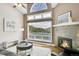 Cozy living room featuring a fireplace, large window and view of the mountains at 33633 Elk Run, Evergreen, CO 80439