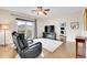 Living room featuring hardwood floors, balcony access with mountain views and a ceiling fan at 33633 Elk Run, Evergreen, CO 80439