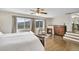Bedroom with hardwood floors, fireplace, windows, and view of mountains at 33633 Elk Run, Evergreen, CO 80439