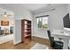 Office space featuring hardwood floors, a window for natural light and a white desk at 33633 Elk Run, Evergreen, CO 80439