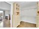 Bright walk-in closet featuring custom built-in shelving, drawers, and hardwood flooring at 33633 Elk Run, Evergreen, CO 80439
