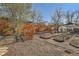 Spacious backyard with a privacy fence, raised garden beds, and greenhouse at 2421 Hooker St, Denver, CO 80211