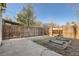 Large backyard featuring a fence, planting beds and a greenhouse at 2421 Hooker St, Denver, CO 80211