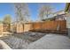 Fenced backyard with brick patio, planting beds and a greenhouse at 2421 Hooker St, Denver, CO 80211