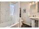 Bathroom with tub, shower, pedestal sink, and tiled walls at 2421 Hooker St, Denver, CO 80211
